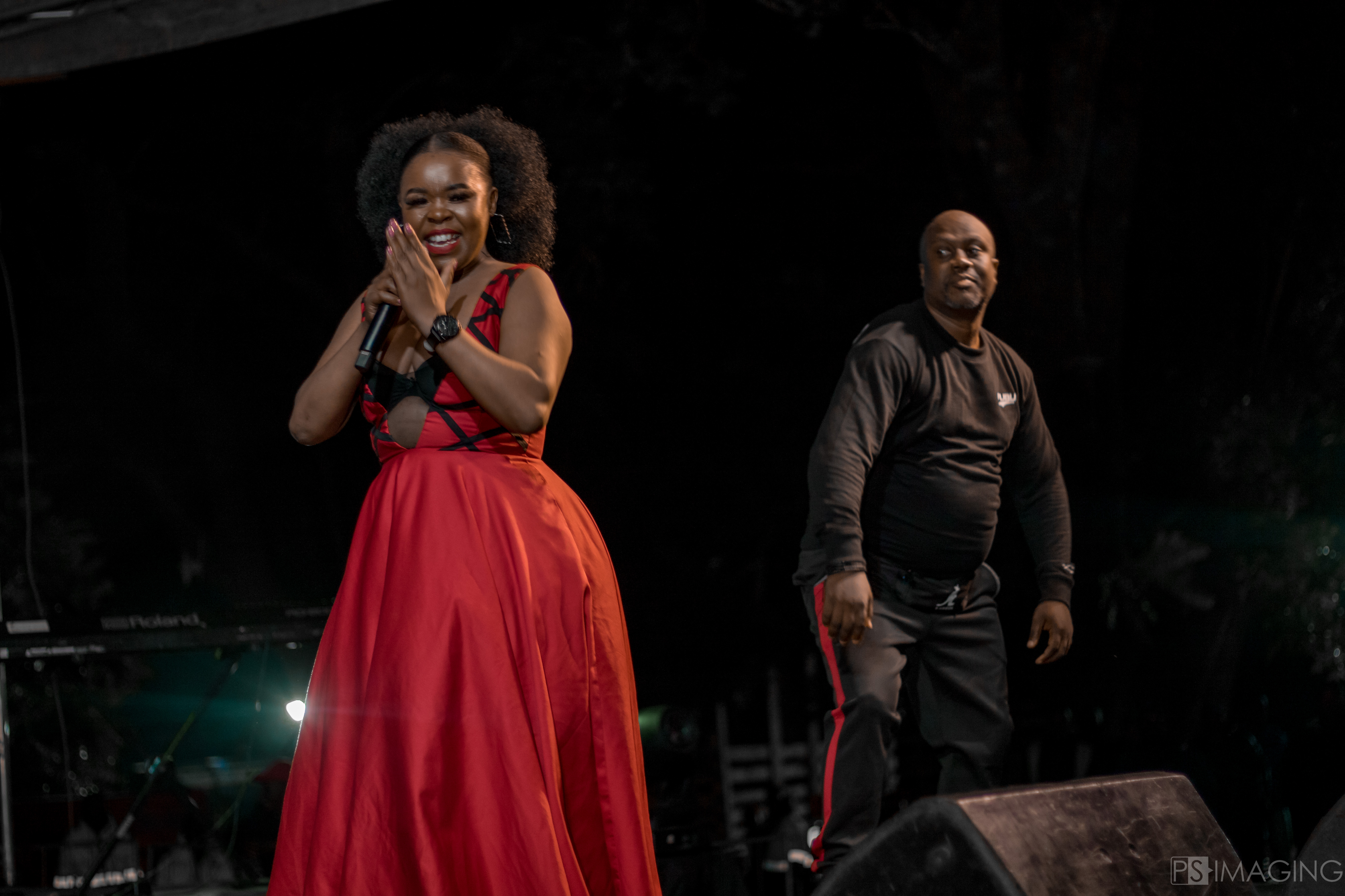 People at a concert facing the stage with various colours of paint powder in the air